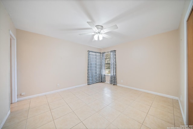 spare room with ceiling fan and light tile patterned flooring