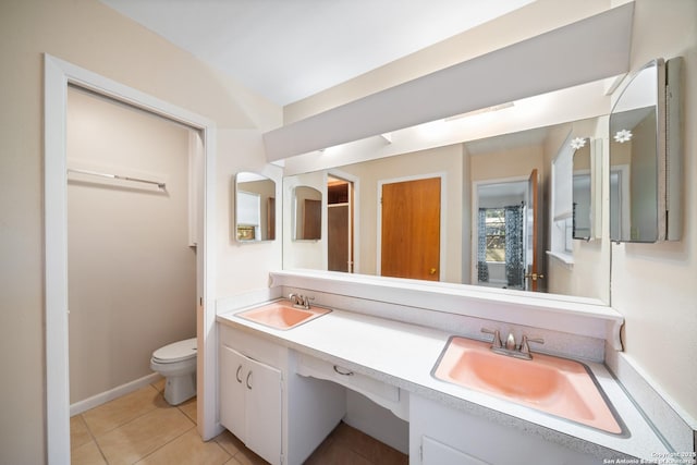 bathroom with vanity, tile patterned floors, and toilet