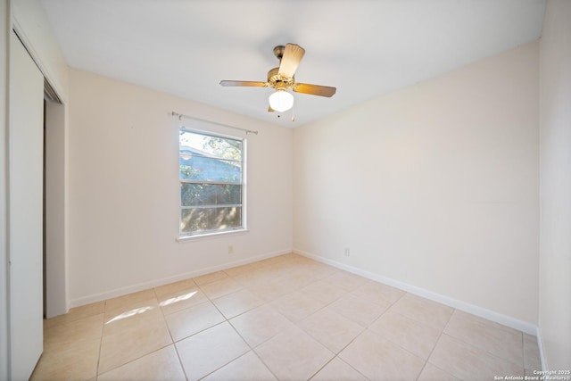 unfurnished bedroom with light tile patterned flooring, ceiling fan, and a closet