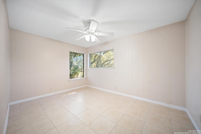 tiled empty room with ceiling fan