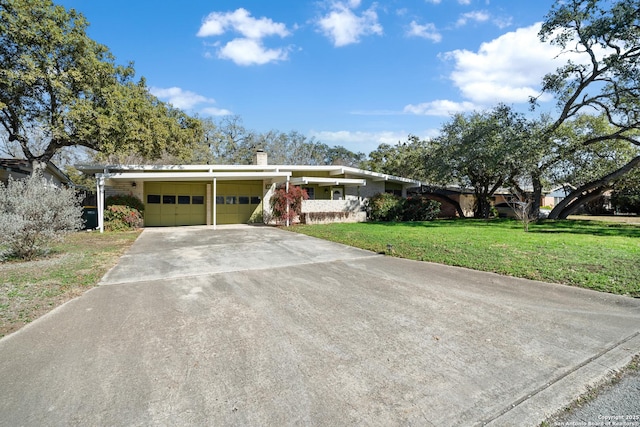 ranch-style house with a garage and a front yard