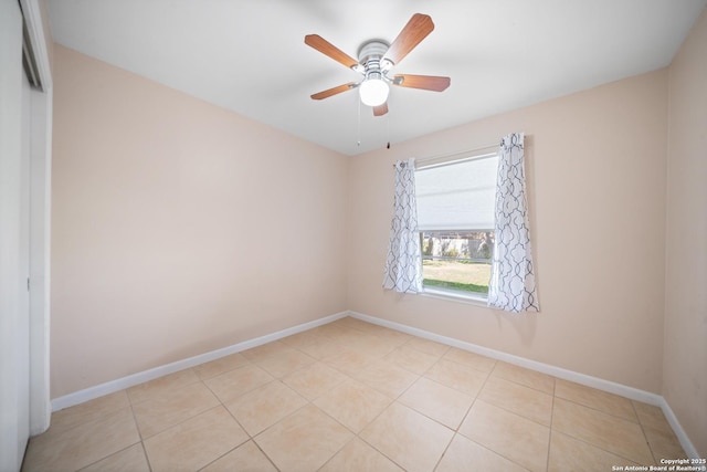 spare room with light tile patterned floors and ceiling fan