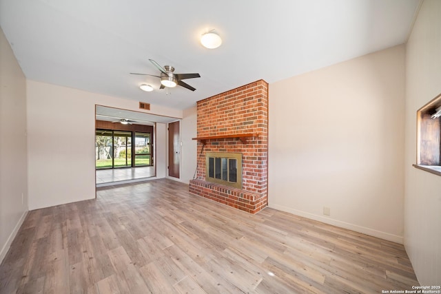 unfurnished living room with ceiling fan, a fireplace, and light wood-type flooring