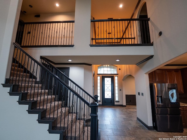 entrance foyer featuring a towering ceiling