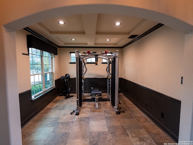 exercise room featuring coffered ceiling