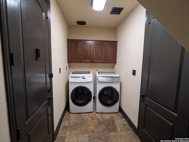 laundry area featuring cabinets and washer and dryer