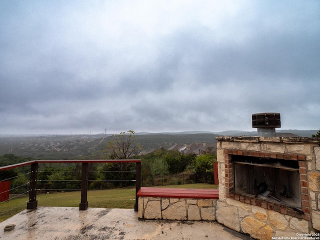 exterior space featuring exterior fireplace and a mountain view