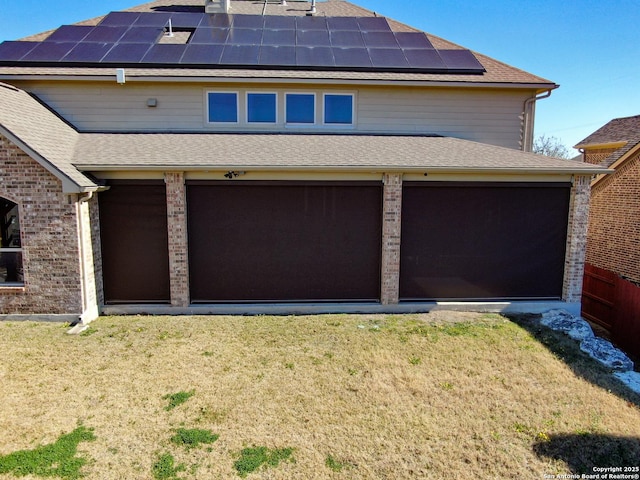 exterior space with a garage and a lawn