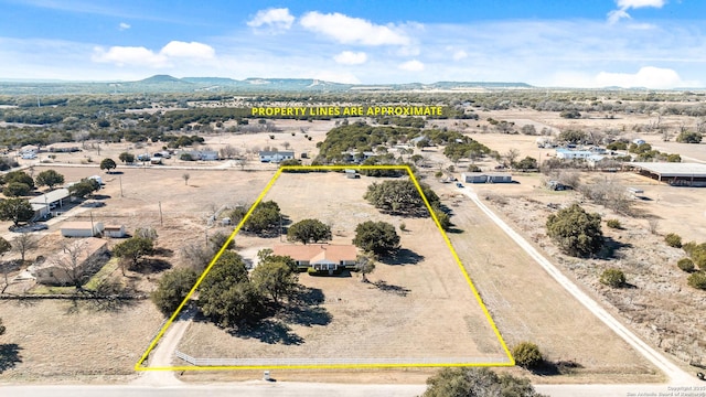 birds eye view of property with a mountain view