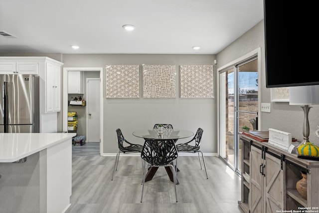 dining space featuring light hardwood / wood-style floors