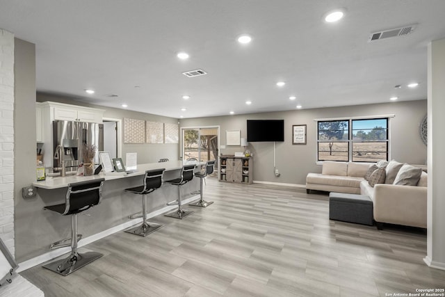 living room with light hardwood / wood-style floors and a wealth of natural light