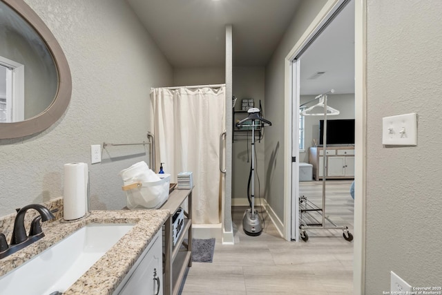 bathroom with vanity and a shower with curtain