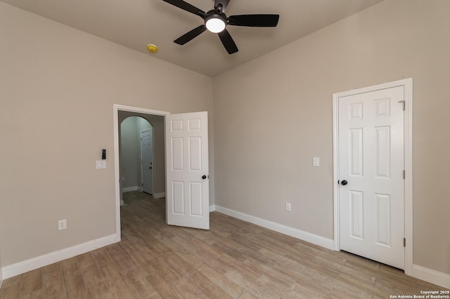 empty room with ceiling fan and light hardwood / wood-style floors