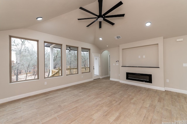 unfurnished living room with vaulted ceiling, light hardwood / wood-style floors, and ceiling fan