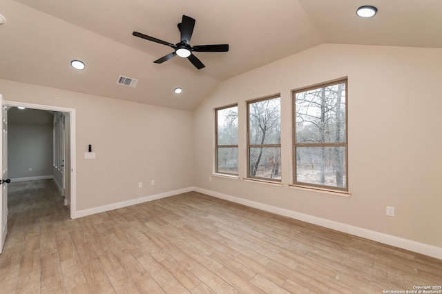 empty room with vaulted ceiling, ceiling fan, and light wood-type flooring