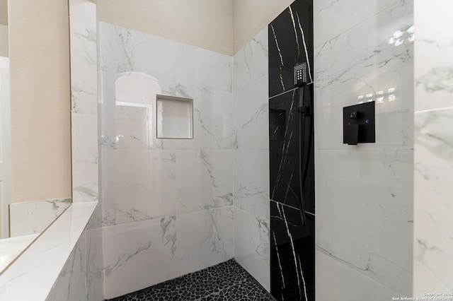 bathroom with a tile shower