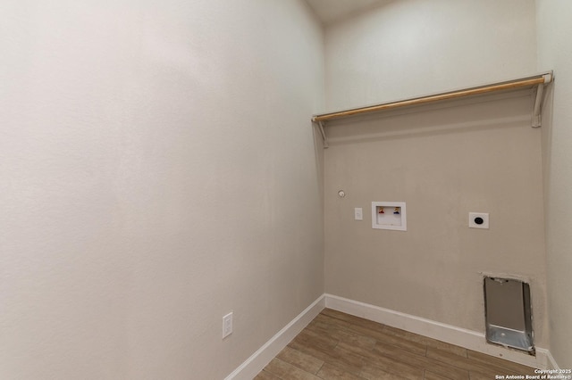 washroom featuring gas dryer hookup, hookup for an electric dryer, hookup for a washing machine, and hardwood / wood-style floors