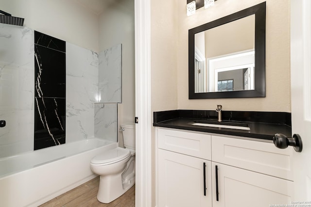 full bathroom with vanity, tiled shower / bath combo, wood-type flooring, and toilet