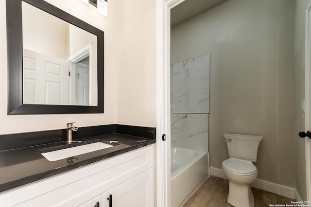 full bathroom with vanity, tub / shower combination, hardwood / wood-style floors, and toilet