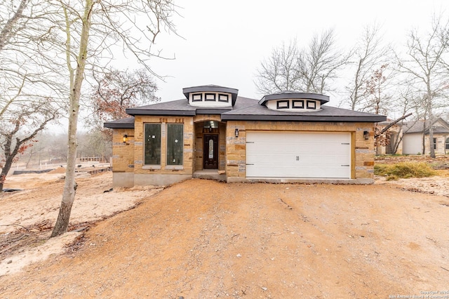 prairie-style house featuring a garage