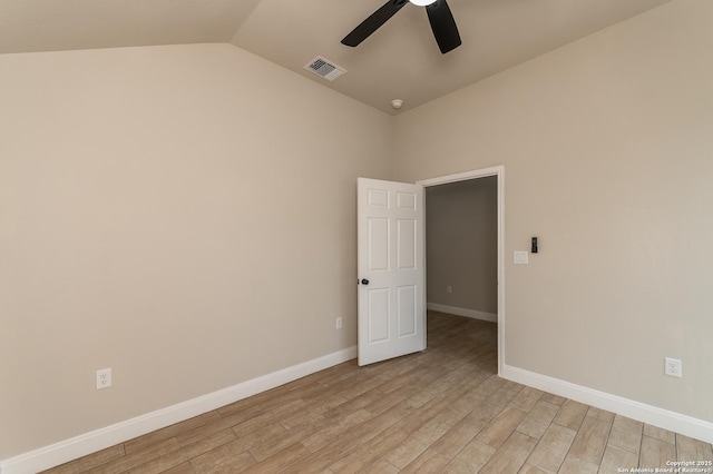 unfurnished room featuring ceiling fan, vaulted ceiling, and light wood-type flooring