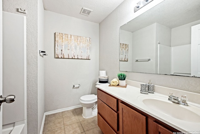 bathroom featuring vanity, walk in shower, toilet, tile patterned floors, and a textured ceiling