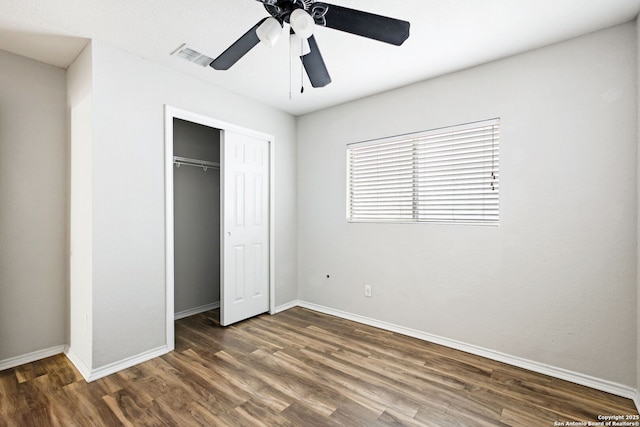 unfurnished bedroom featuring a closet, dark hardwood / wood-style floors, and ceiling fan