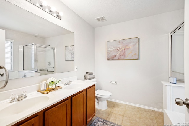 bathroom with a shower with door, vanity, a textured ceiling, and toilet