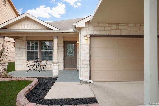 entrance to property with a garage and a porch