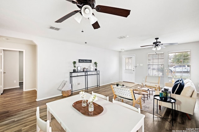 dining space featuring ceiling fan and dark hardwood / wood-style flooring