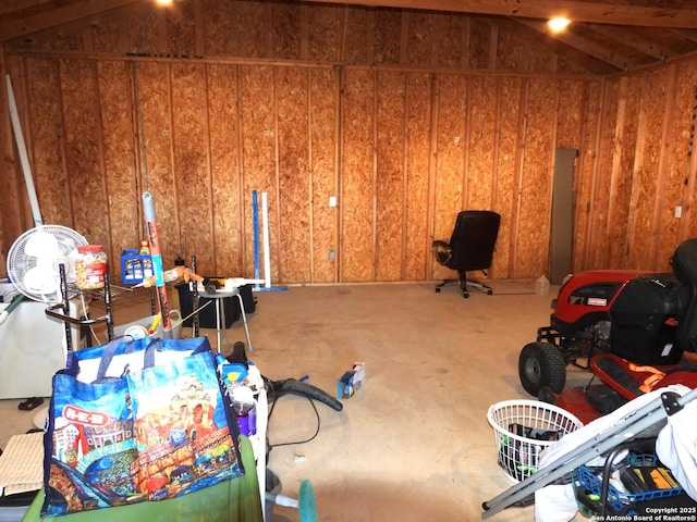 interior space featuring wooden walls and vaulted ceiling