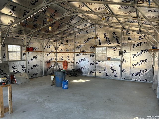 miscellaneous room with vaulted ceiling and concrete floors