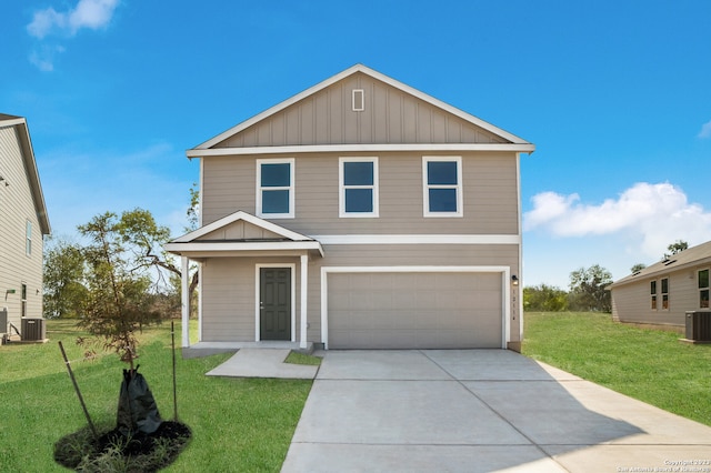 view of front of home with cooling unit, a garage, and a front yard