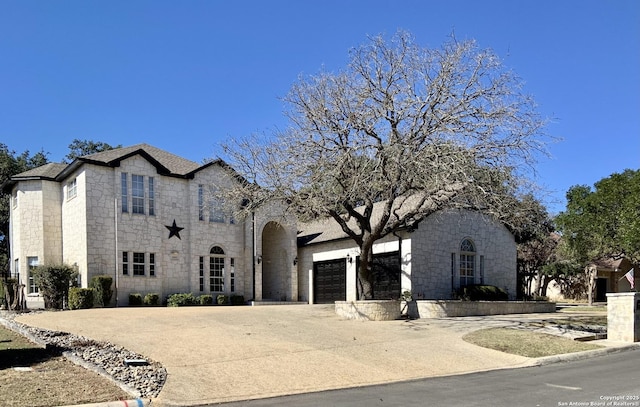 french country style house with a garage