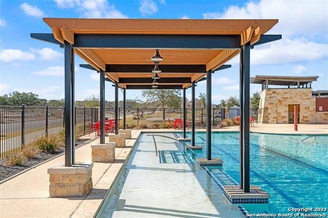 view of pool with a fireplace and a patio area