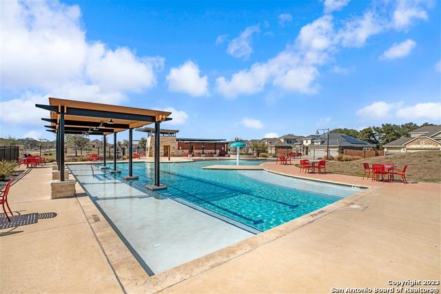 view of pool with pool water feature and a patio area