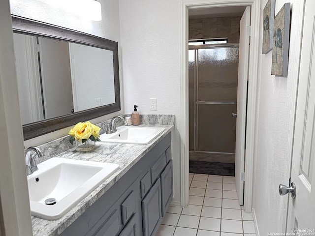 bathroom featuring tile patterned flooring and vanity