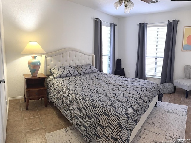 tiled bedroom featuring multiple windows