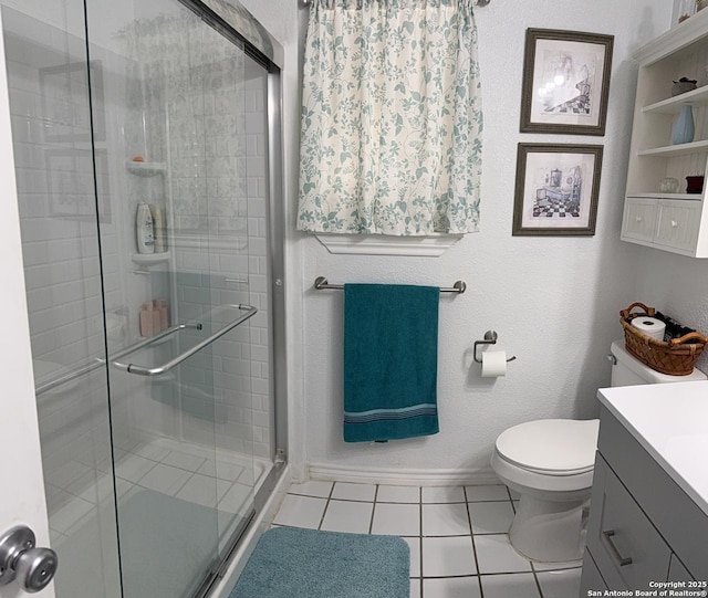 bathroom with an enclosed shower, vanity, tile patterned flooring, and toilet