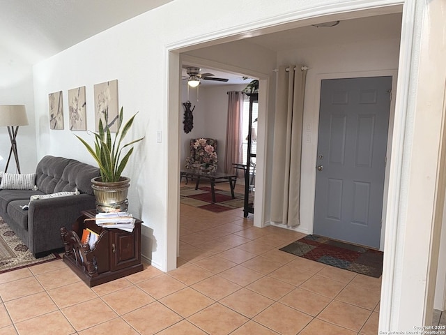 tiled entryway with ceiling fan