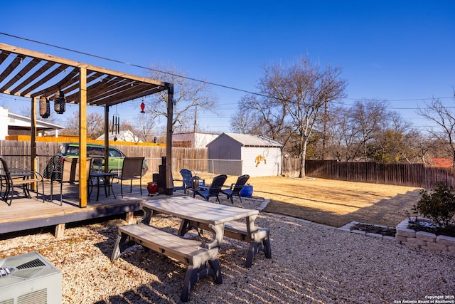 view of yard featuring a deck and a storage unit