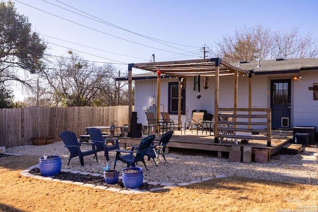 back of house featuring a wooden deck and an outdoor fire pit