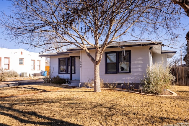 view of front facade with central AC and a front yard