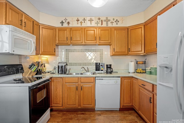 kitchen with sink, white appliances, and backsplash