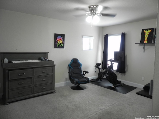 exercise area with ceiling fan and carpet