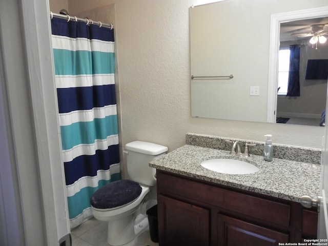 bathroom with ceiling fan, a shower with shower curtain, vanity, tile patterned floors, and toilet