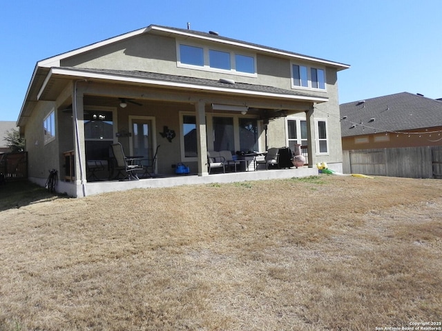 back of property featuring ceiling fan and a patio area