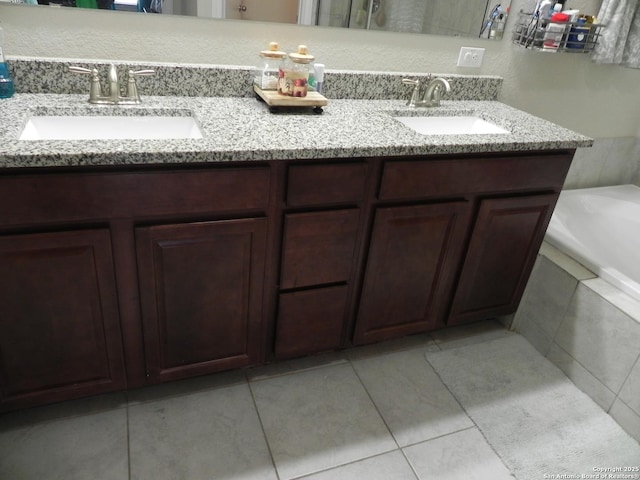 bathroom featuring vanity and tiled bath