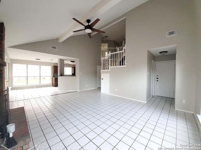 unfurnished living room with ceiling fan, beam ceiling, high vaulted ceiling, and light tile patterned floors