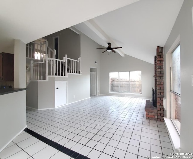 unfurnished living room featuring light tile patterned floors, high vaulted ceiling, and ceiling fan